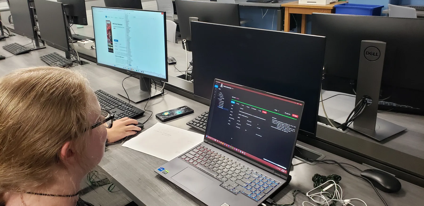 Student working at a desktop computer during cybersecurity competition activity